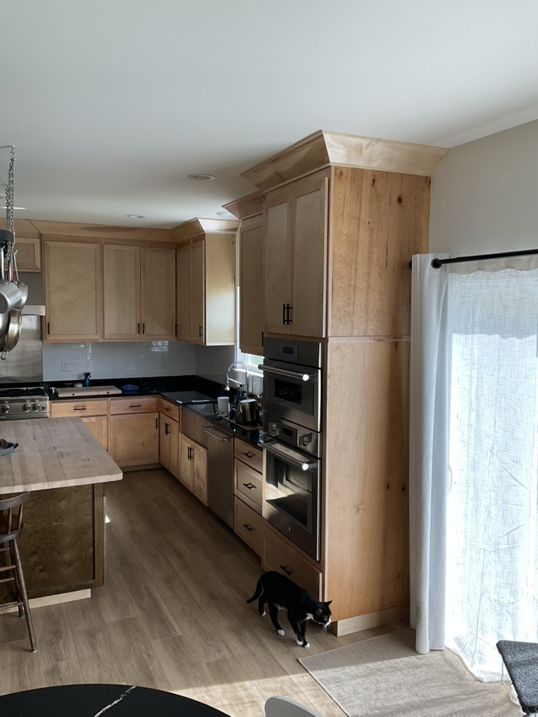 Shadow Point natural wood cabinetry and appliance wall